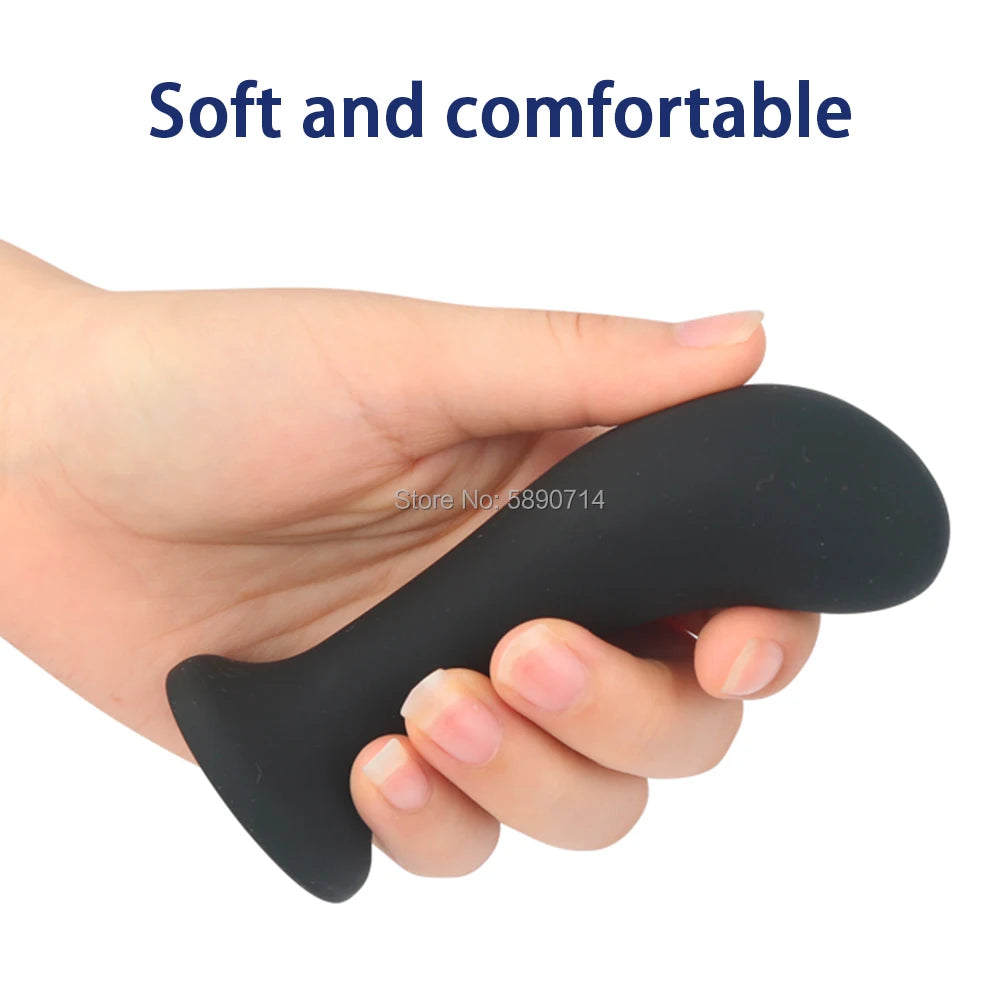 Black silicone massager held in a hand with text 'Soft and comfortable' on a white background